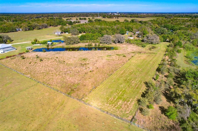 birds eye view of property featuring a rural view and a water view