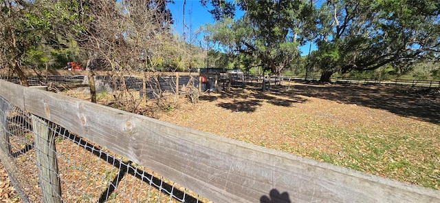 view of yard featuring a rural view and fence