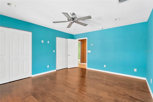 unfurnished bedroom featuring a ceiling fan, baseboards, and wood finished floors