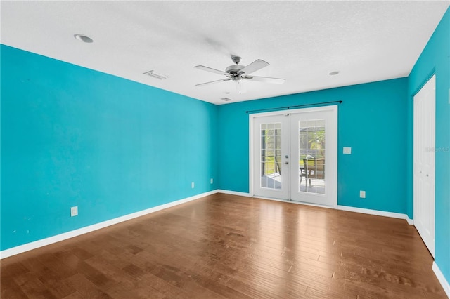 spare room with visible vents, wood finished floors, french doors, baseboards, and ceiling fan