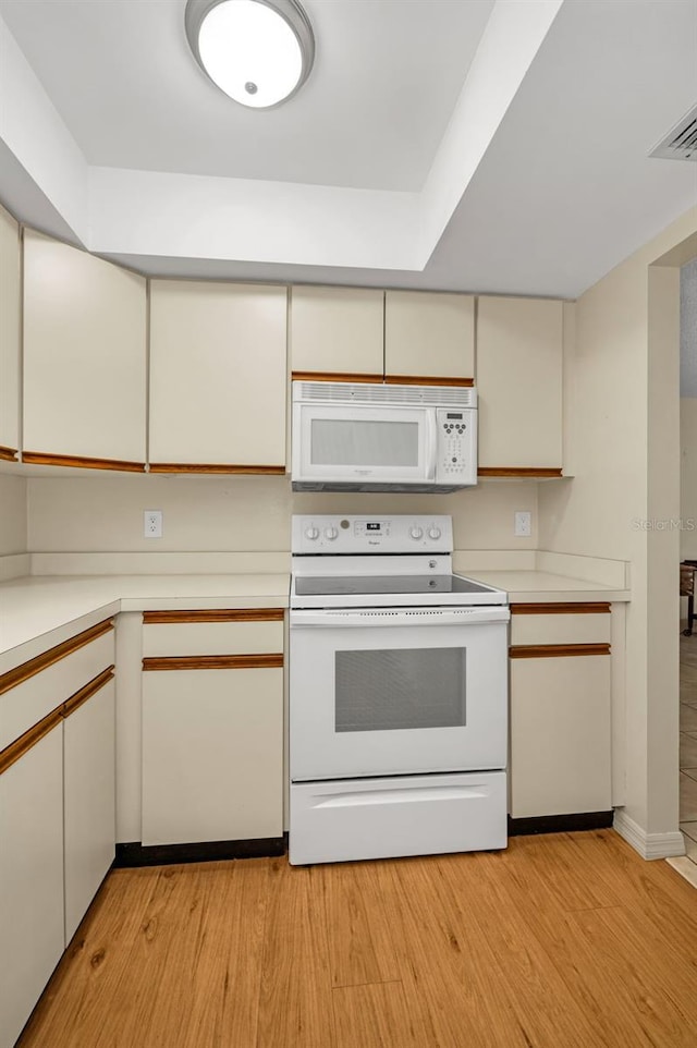 kitchen with visible vents, light countertops, white appliances, and light wood-style flooring