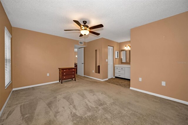 unfurnished bedroom with visible vents, carpet flooring, ceiling fan, a textured ceiling, and baseboards