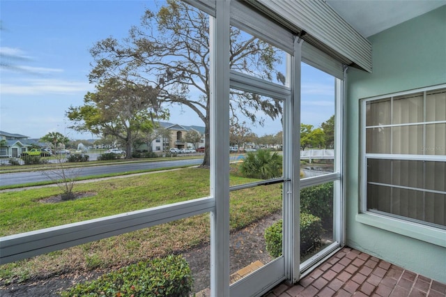 unfurnished sunroom featuring a residential view