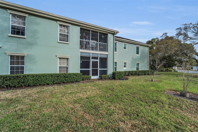 back of house with a lawn