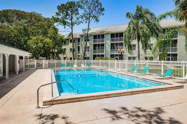 community pool featuring a patio area and fence