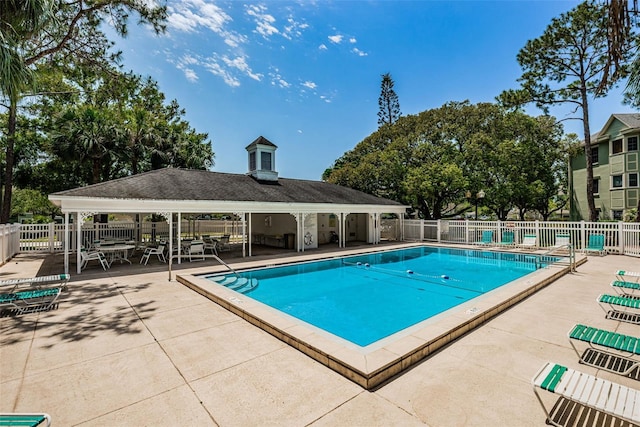 pool featuring a patio and fence