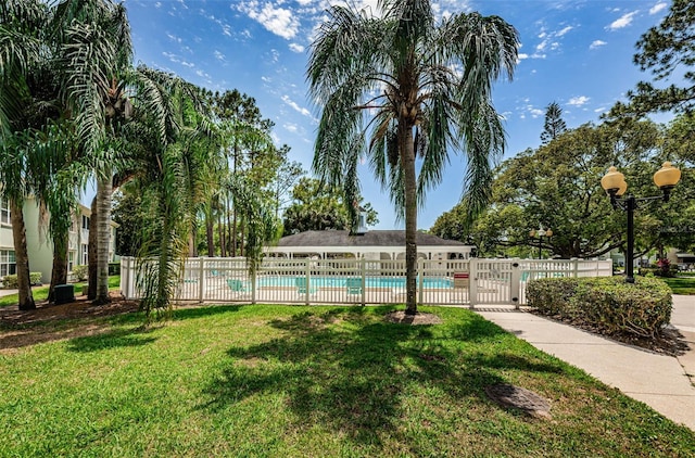 exterior space featuring a lawn and fence