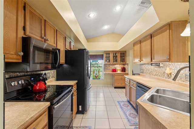 kitchen with visible vents, vaulted ceiling, stainless steel appliances, a sink, and light tile patterned flooring