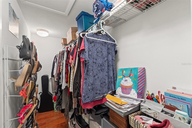 spacious closet featuring attic access and wood finished floors