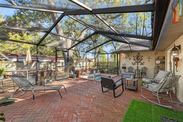 view of patio / terrace featuring glass enclosure and a fenced backyard