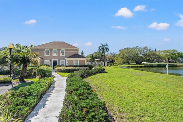 exterior space with a front lawn and a water view