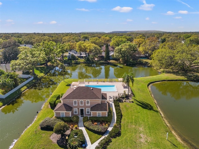 drone / aerial view with a water view and a wooded view