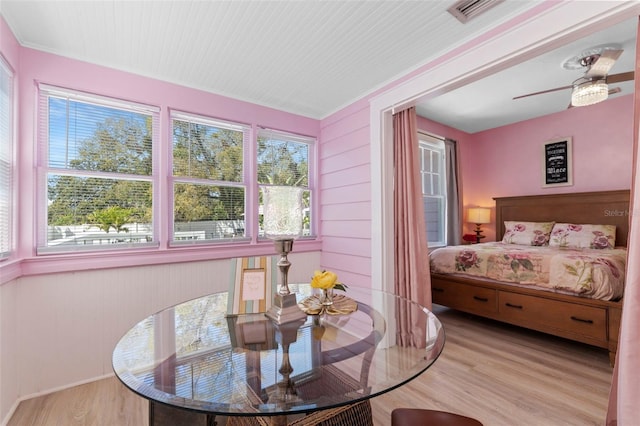 bedroom featuring a ceiling fan, visible vents, and wood finished floors