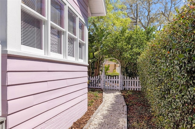 view of home's exterior featuring fence