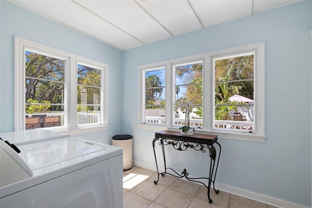 laundry room featuring light tile patterned floors, laundry area, and baseboards