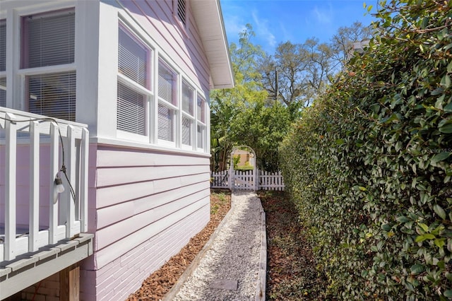 view of side of home featuring fence