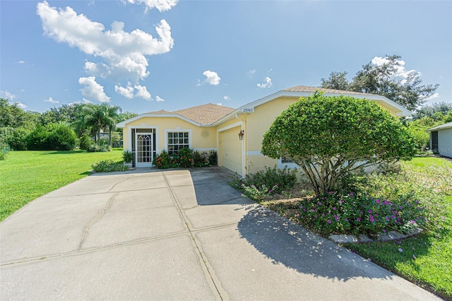 view of front of property featuring driveway, a front lawn, an attached garage, and stucco siding