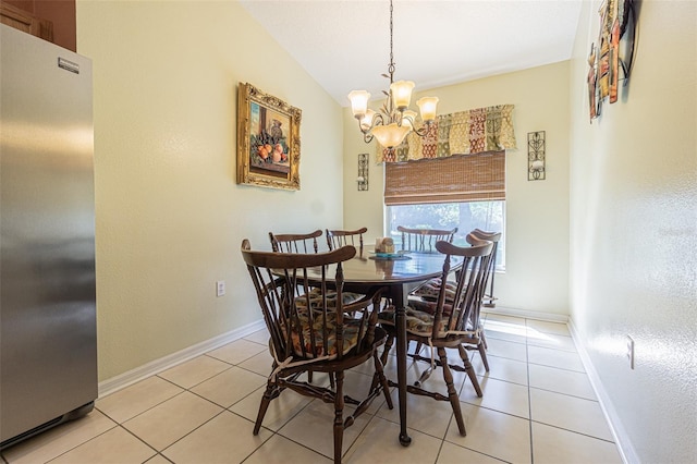 dining area with light tile patterned floors, baseboards, a chandelier, and vaulted ceiling