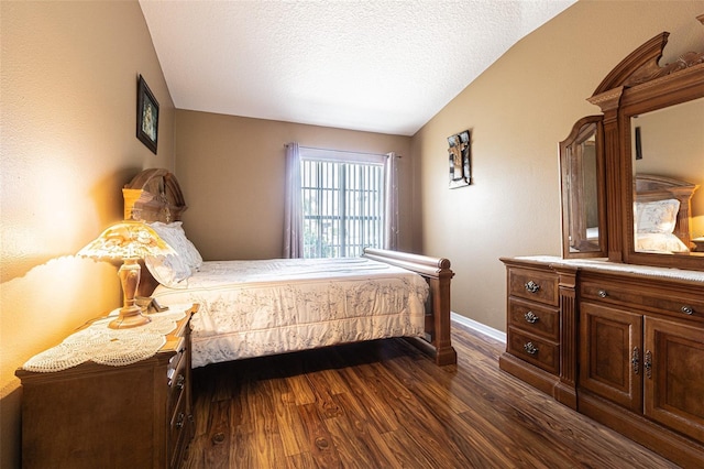 bedroom featuring lofted ceiling, dark wood-style floors, baseboards, and a textured ceiling