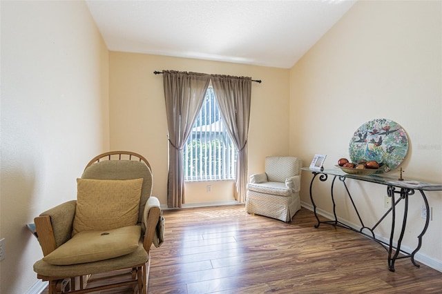 sitting room featuring baseboards and wood finished floors