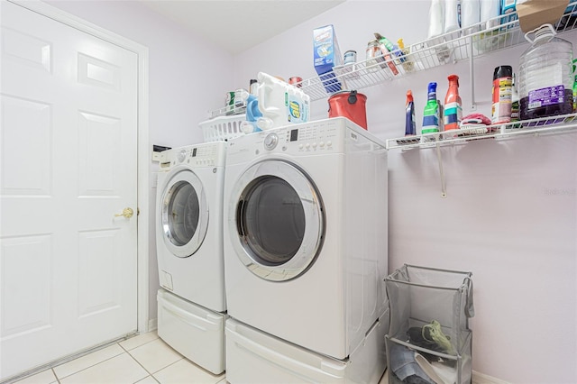 laundry room with light tile patterned floors, laundry area, and washer and dryer