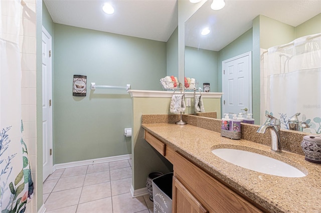 bathroom featuring a shower with shower curtain, tile patterned flooring, vanity, and baseboards