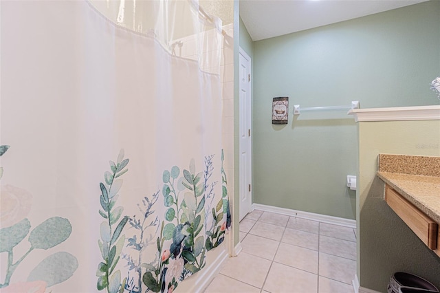 full bathroom with baseboards, a shower with curtain, vanity, and tile patterned floors