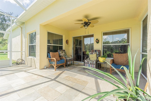 sunroom featuring a skylight, plenty of natural light, and ceiling fan