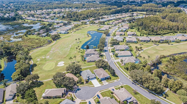 drone / aerial view featuring a residential view, a water view, and golf course view