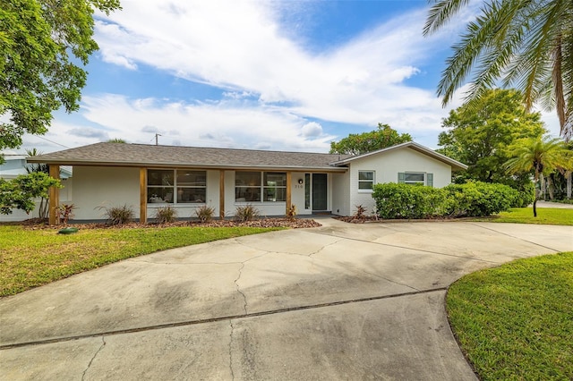 ranch-style house with stucco siding and a front lawn