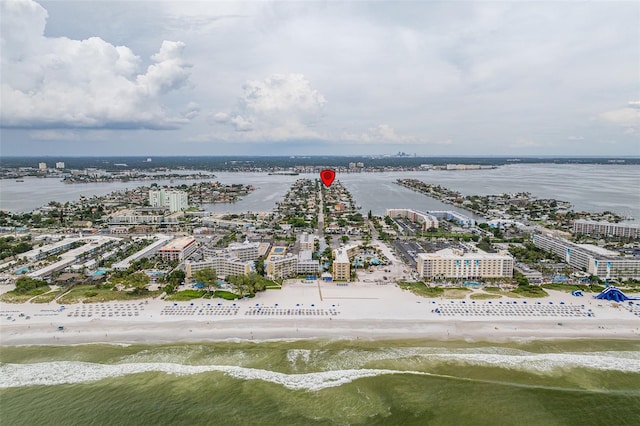 drone / aerial view with a water view, a view of city, and a beach view