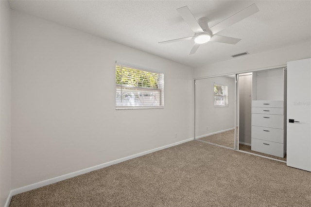 unfurnished bedroom featuring a closet, baseboards, carpet, and visible vents