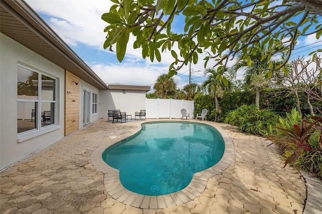 view of pool featuring a patio, a fenced backyard, and a fenced in pool