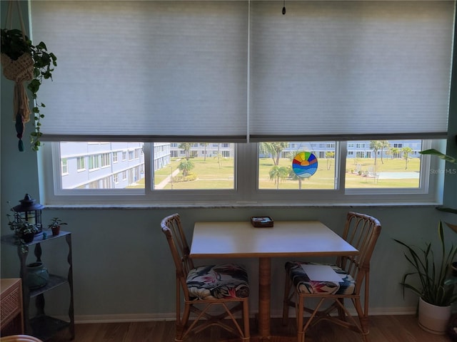 dining room featuring plenty of natural light, baseboards, and wood finished floors