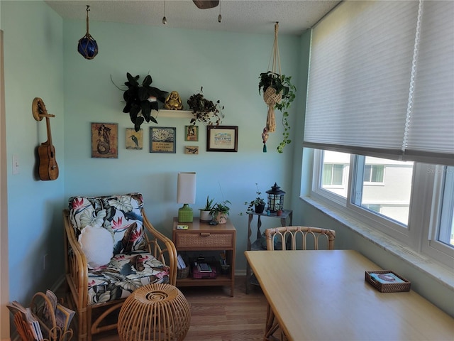 dining area with a textured ceiling and wood finished floors