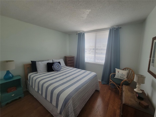 bedroom featuring a textured ceiling and wood finished floors