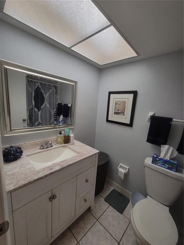 bathroom featuring a shower with curtain, vanity, toilet, and tile patterned floors