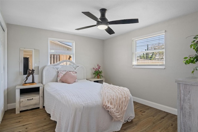 bedroom featuring a ceiling fan, baseboards, and wood finished floors