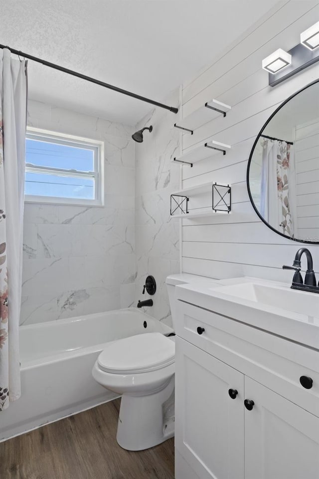 bathroom with shower / bathtub combination with curtain, toilet, vanity, and wood finished floors