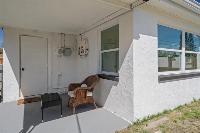 doorway to property featuring stucco siding