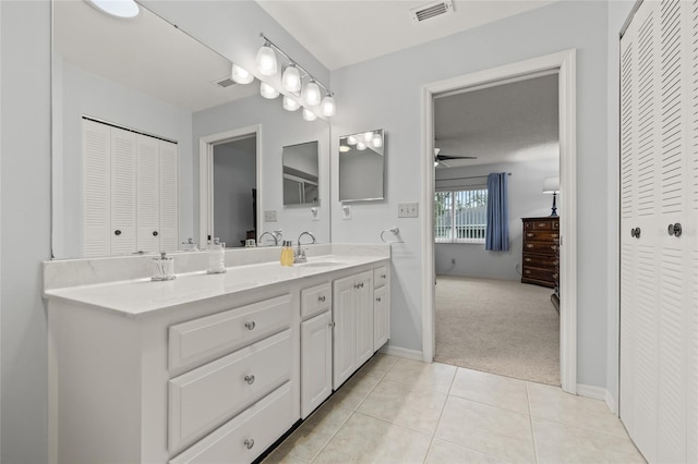 bathroom featuring visible vents, tile patterned floors, ceiling fan, a closet, and vanity