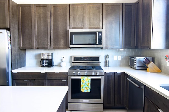 kitchen featuring appliances with stainless steel finishes, light countertops, decorative backsplash, and dark brown cabinets