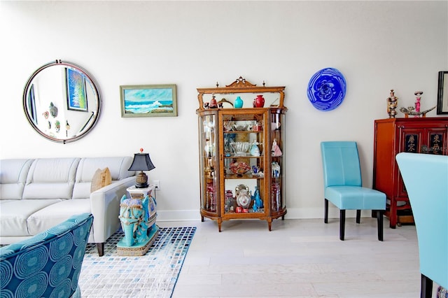 living area featuring baseboards and wood finished floors