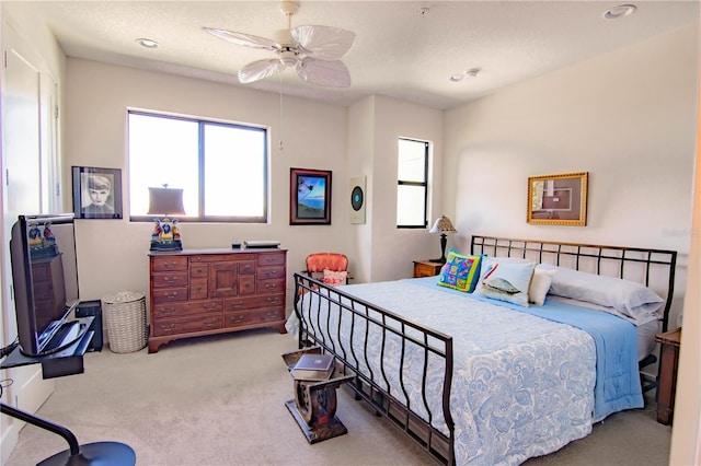 carpeted bedroom with a textured ceiling, a ceiling fan, and recessed lighting