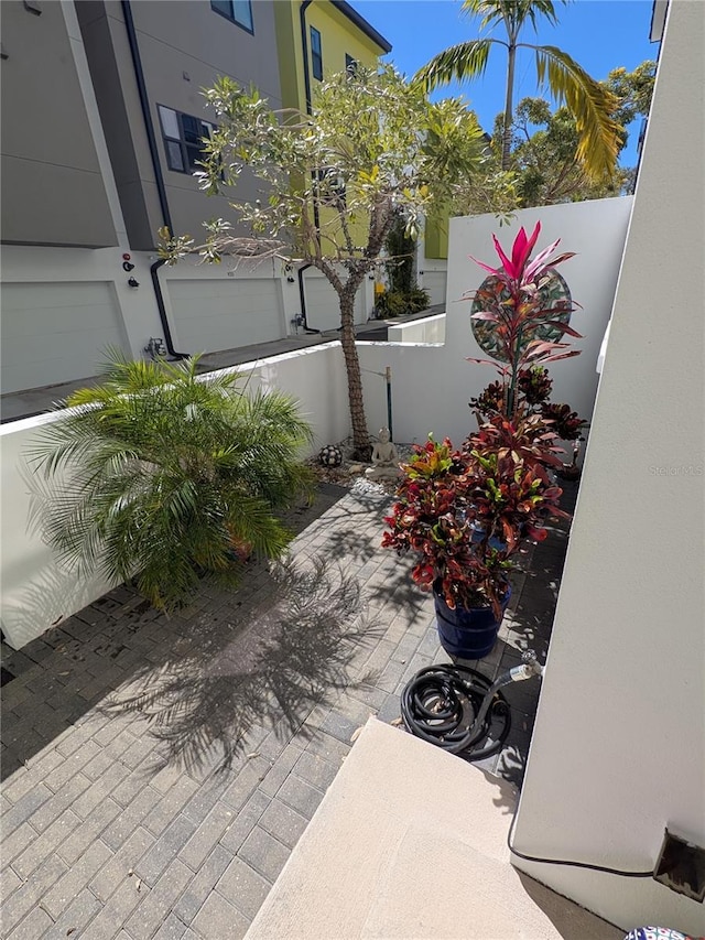 view of patio / terrace with a garage and fence