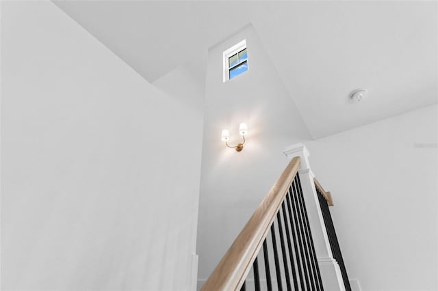 stairway featuring lofted ceiling