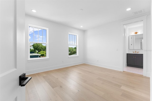 interior space featuring baseboards, recessed lighting, visible vents, and light wood-style floors