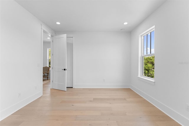 unfurnished room featuring recessed lighting, light wood-type flooring, and baseboards