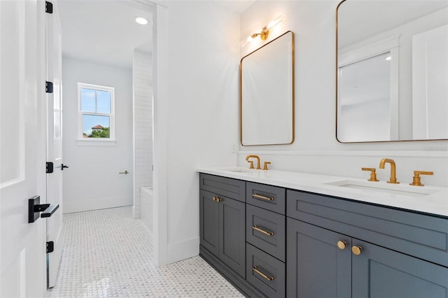 full bathroom featuring tile patterned flooring, a sink, baseboards, and double vanity