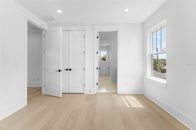 unfurnished bedroom featuring baseboards, light wood-type flooring, visible vents, and recessed lighting